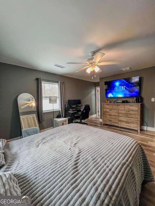 bedroom featuring hardwood / wood-style floors and ceiling fan