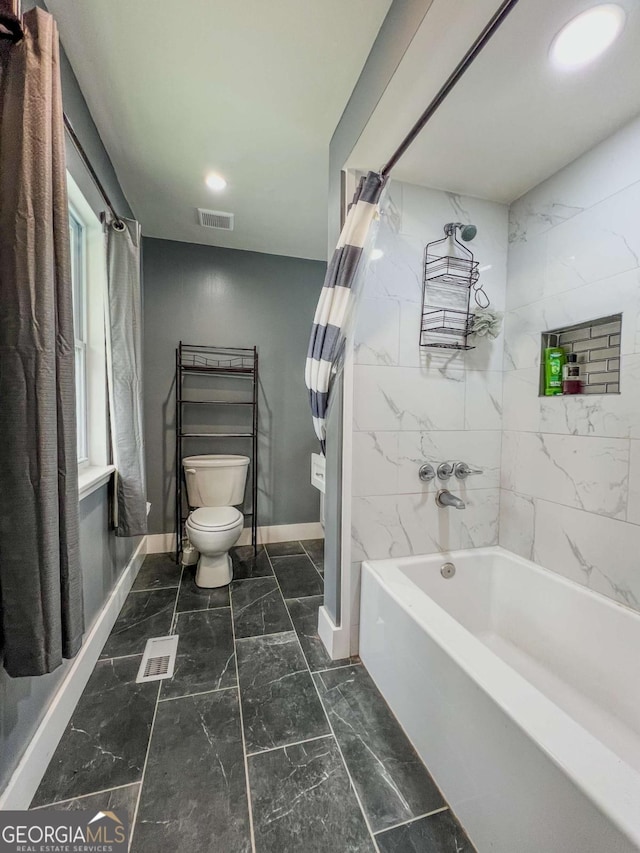 bathroom with toilet and shower / bathtub combination with curtain