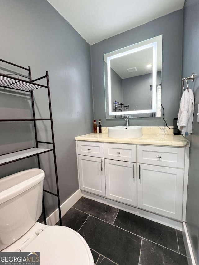 bathroom featuring vanity and toilet