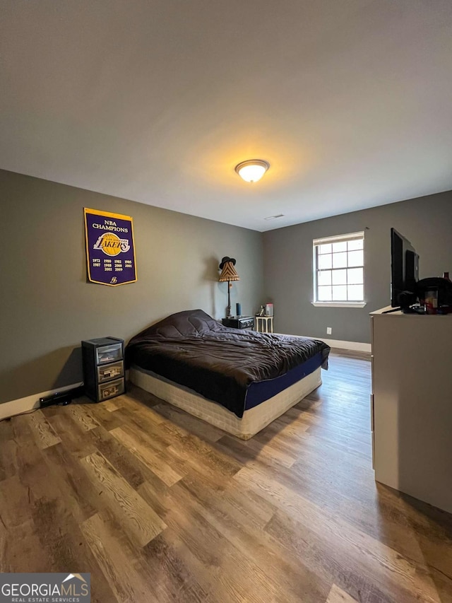 bedroom featuring wood-type flooring