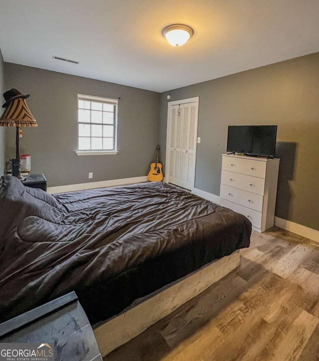 bedroom featuring a closet and light hardwood / wood-style floors