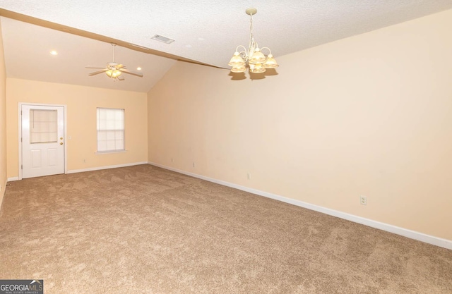 carpeted spare room with a textured ceiling, ceiling fan with notable chandelier, and vaulted ceiling