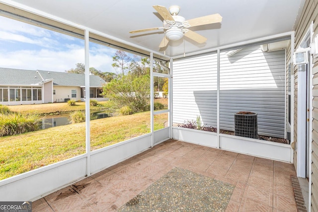 unfurnished sunroom with ceiling fan