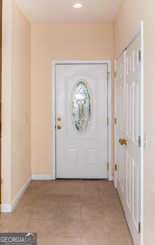 doorway featuring light tile patterned floors