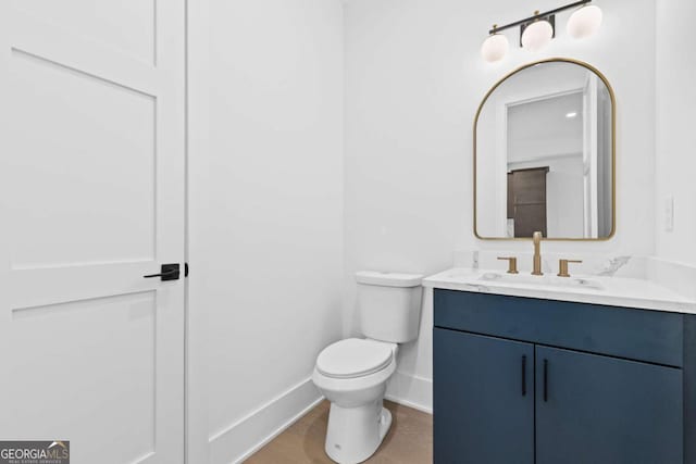 bathroom featuring toilet, hardwood / wood-style flooring, and vanity