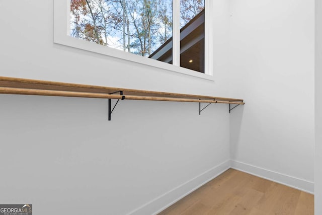 walk in closet featuring hardwood / wood-style flooring