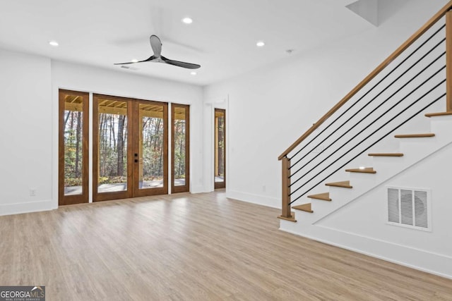 foyer entrance with ceiling fan, french doors, and light wood-type flooring