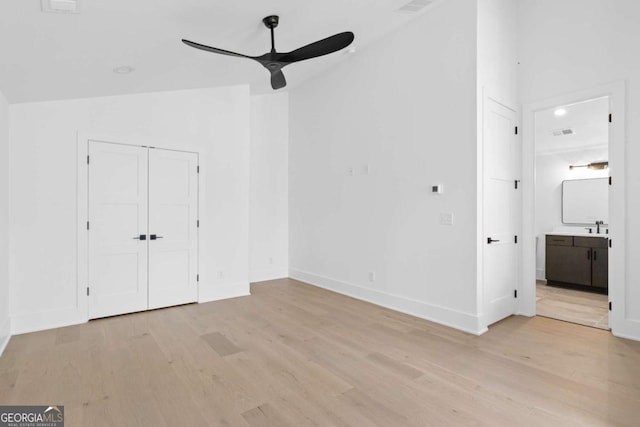 interior space featuring ceiling fan, light wood-type flooring, and lofted ceiling