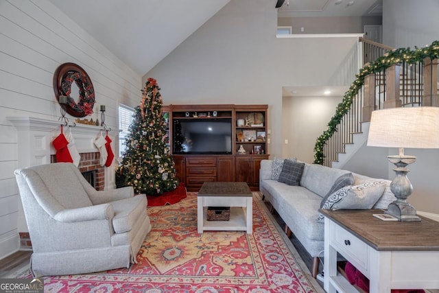 living room featuring high vaulted ceiling and light wood-type flooring