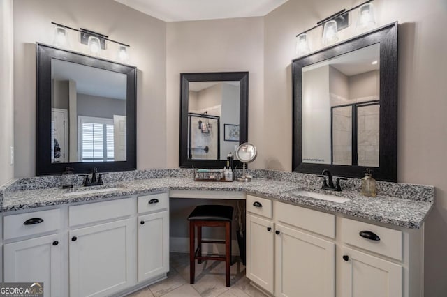 bathroom featuring vanity and an enclosed shower