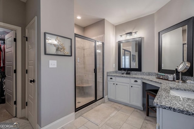 bathroom featuring vanity and a shower with shower door