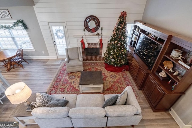 living room with a fireplace and light wood-type flooring