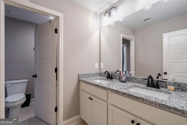 bathroom featuring vanity, tile patterned flooring, and toilet