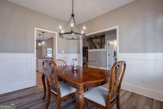 dining room with hardwood / wood-style floors and a notable chandelier