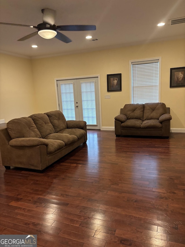 living room featuring crown molding, baseboards, dark wood-style flooring, and french doors