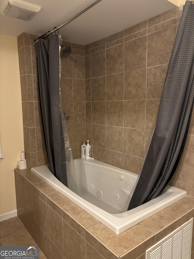 bathroom with tile patterned flooring, a combined bath / shower with jetted tub, and visible vents