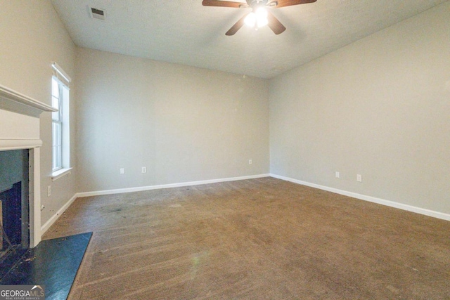 unfurnished living room with ceiling fan, dark carpet, and lofted ceiling