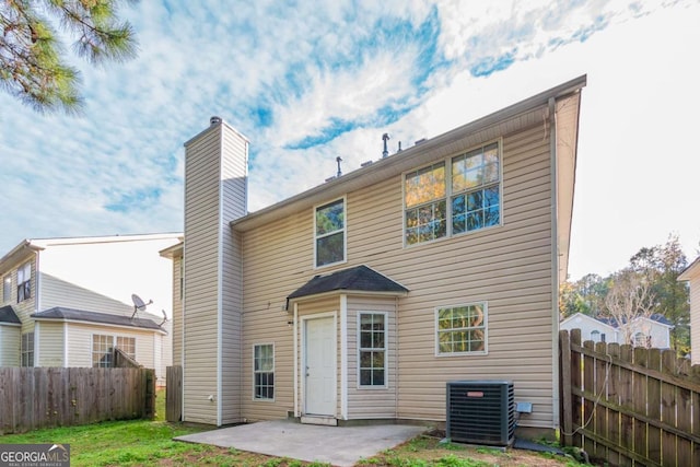 back of property with cooling unit and a patio area