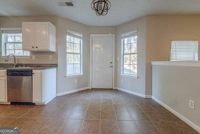 kitchen with tile patterned flooring, dishwasher, white cabinetry, and sink