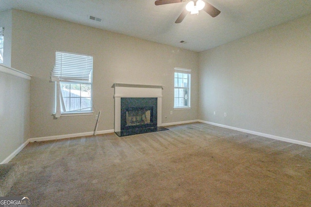 unfurnished living room with ceiling fan and carpet floors