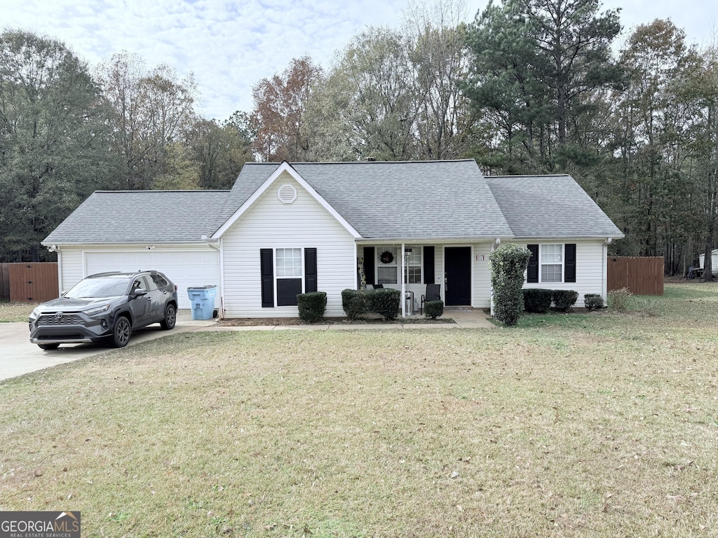 single story home with a garage and a front yard