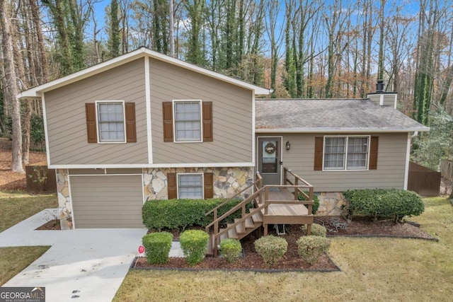 split level home with a front yard and a garage