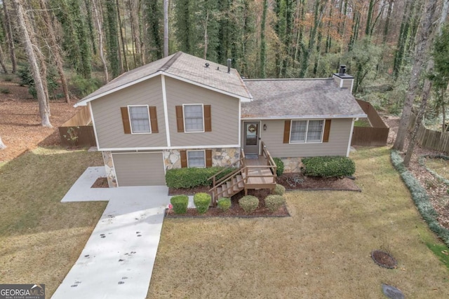 split level home with a front lawn and a garage