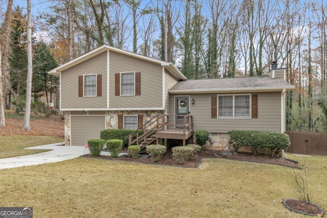 split level home featuring a garage and a front yard