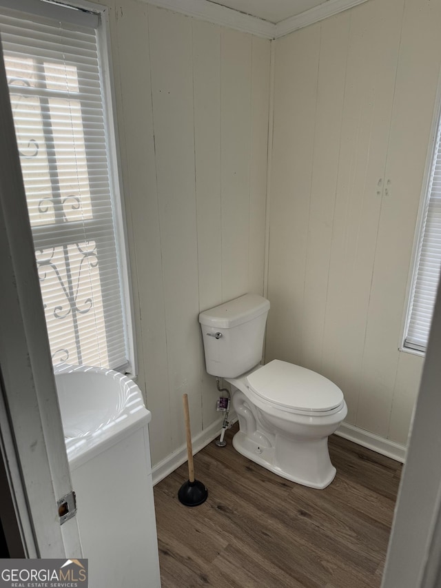 bathroom featuring hardwood / wood-style floors, vanity, wood walls, and toilet