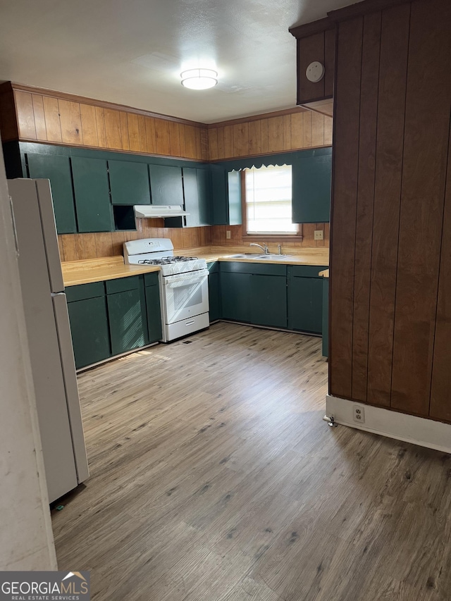 kitchen with sink, white appliances, and light wood-type flooring