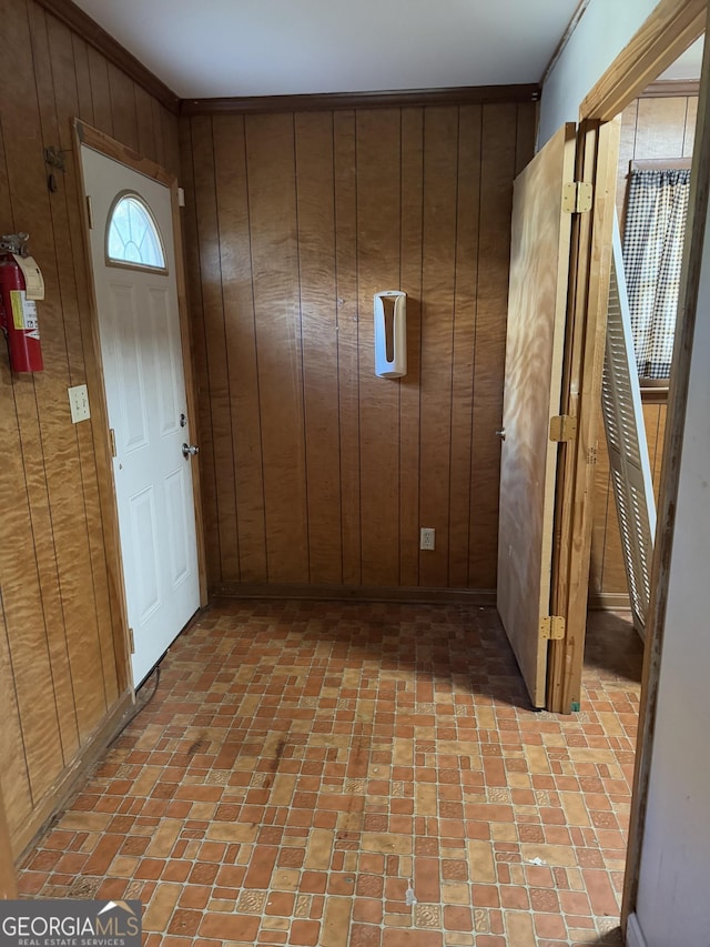 entryway featuring wood walls