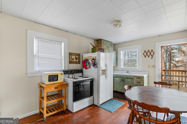 kitchen featuring white appliances, dark hardwood / wood-style floors, and sink