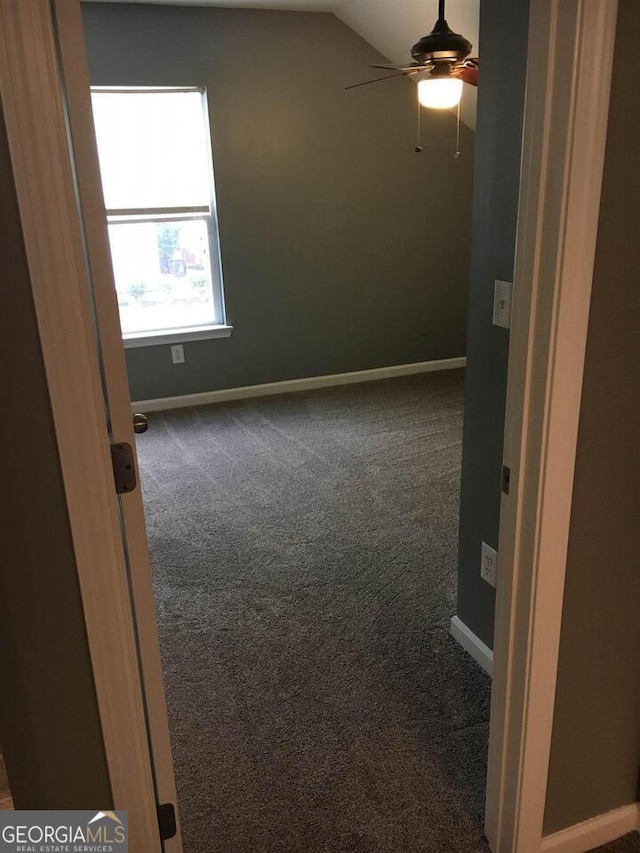 carpeted empty room featuring ceiling fan and lofted ceiling