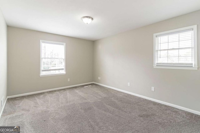 empty room with carpet and plenty of natural light