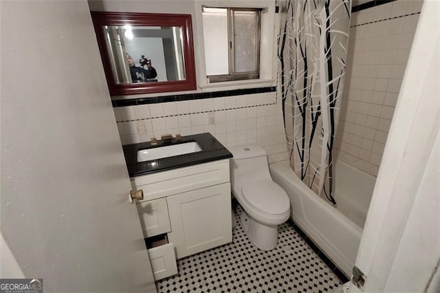 full bathroom featuring shower / bath combo, backsplash, vanity, tile walls, and toilet