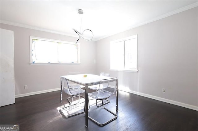 dining area with plenty of natural light, dark hardwood / wood-style floors, and ornamental molding