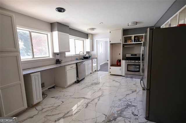 kitchen with white cabinetry, a healthy amount of sunlight, and appliances with stainless steel finishes