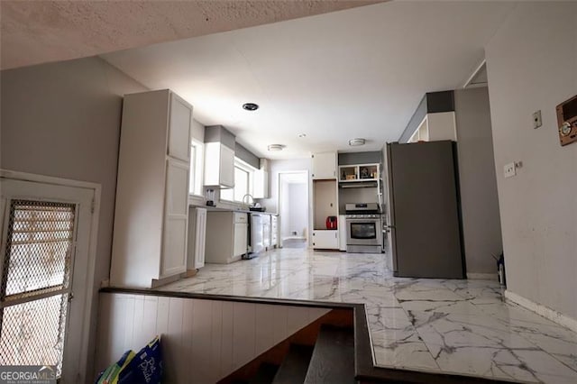 kitchen with white cabinetry, a textured ceiling, and appliances with stainless steel finishes