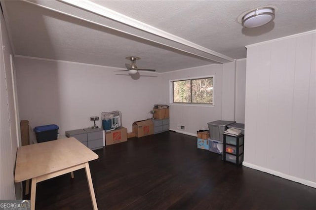 interior space with ornamental molding, a textured ceiling, ceiling fan, and dark wood-type flooring