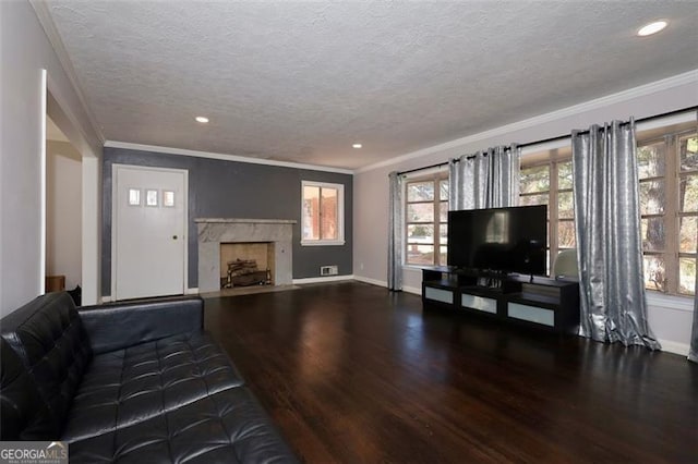 unfurnished living room with hardwood / wood-style floors, a premium fireplace, a textured ceiling, and ornamental molding