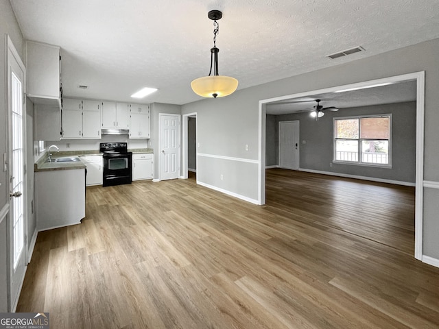 kitchen featuring white cabinetry, black range with electric stovetop, sink, and light hardwood / wood-style flooring