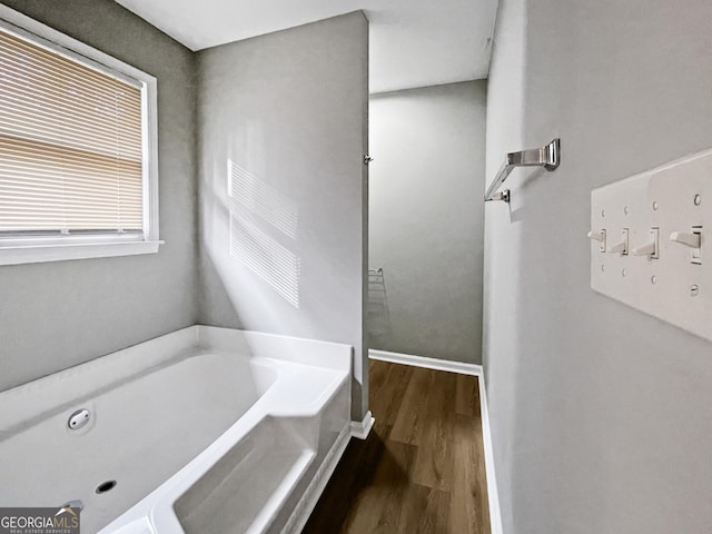 165 Riverbend Dr, Covington, GA 30014 - bathroom with a bath and hardwood / wood-style flooring