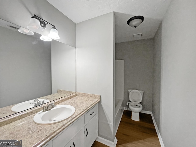 165 Riverbend Dr, Covington, GA 30014 - bathroom featuring a shower, vanity, wood-type flooring, and toilet