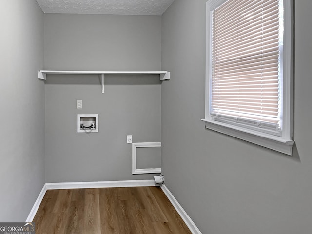 165 Riverbend Dr, Covington, GA 30014 - clothes washing area featuring wood-type flooring, a textured ceiling, and hookup for a washing machine