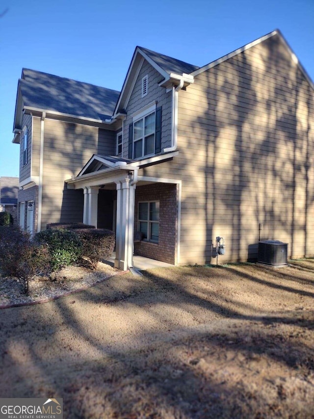 view of home's exterior featuring central air condition unit and a garage