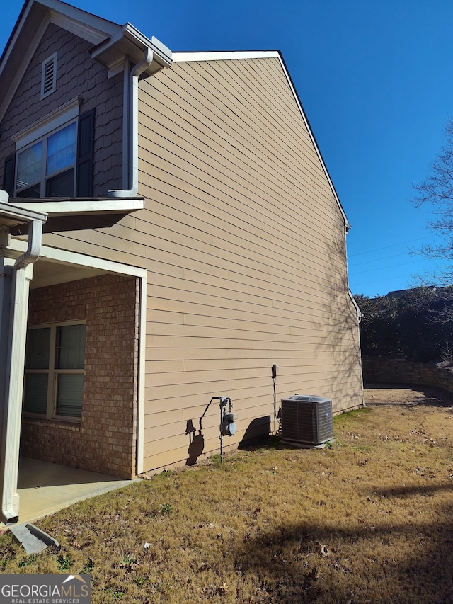 view of property exterior featuring a patio area and cooling unit