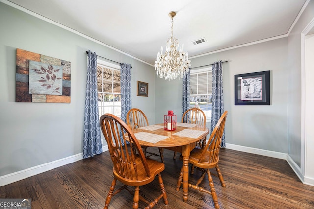 dining space featuring crown molding, a healthy amount of sunlight, dark hardwood / wood-style floors, and an inviting chandelier