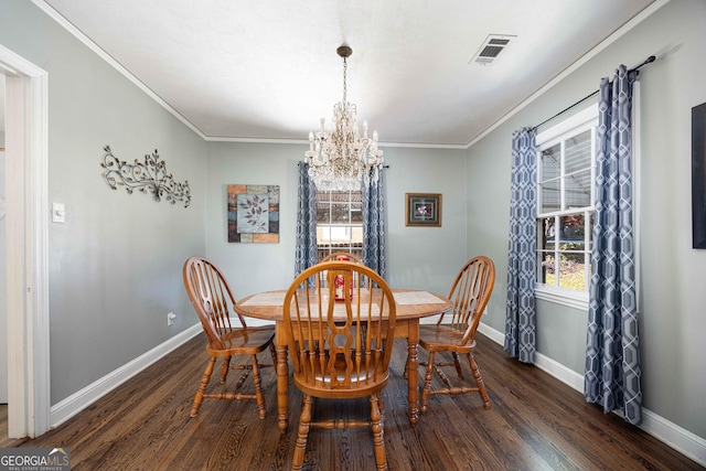 dining space with an inviting chandelier, dark wood-type flooring, and ornamental molding