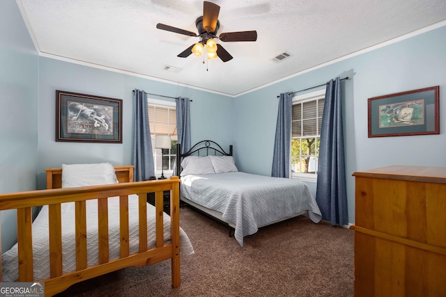 bedroom with a textured ceiling, carpet floors, ceiling fan, and crown molding