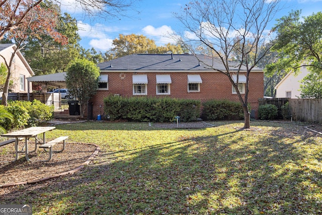 rear view of house with a yard